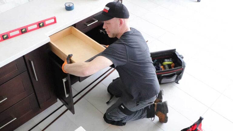 man istalling kitchen drawer and cabinets